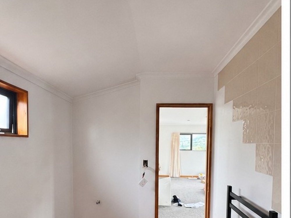 Hallway after painting with polished timber floor, Wellington home